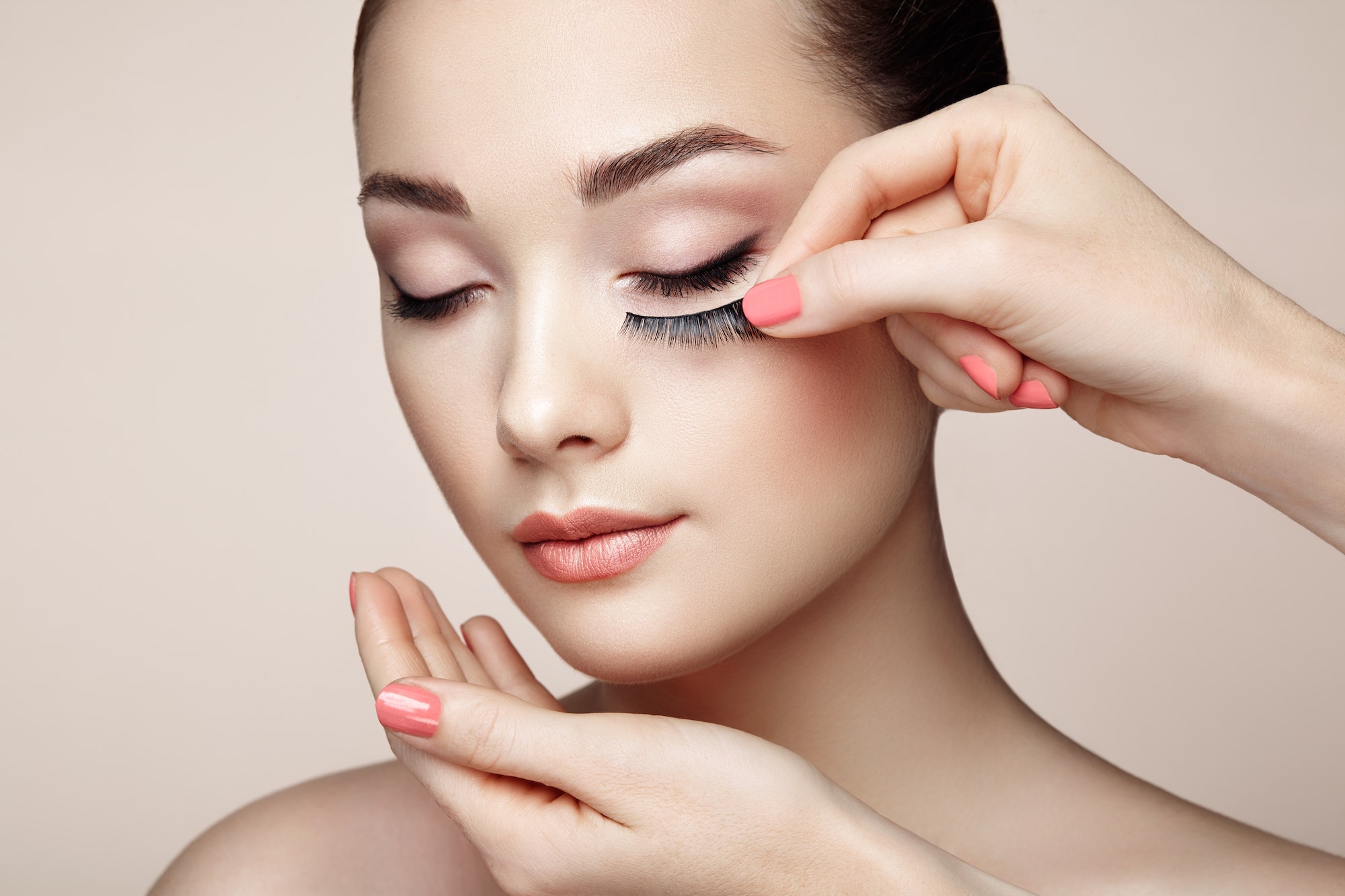Makeup artist glues eyelashes